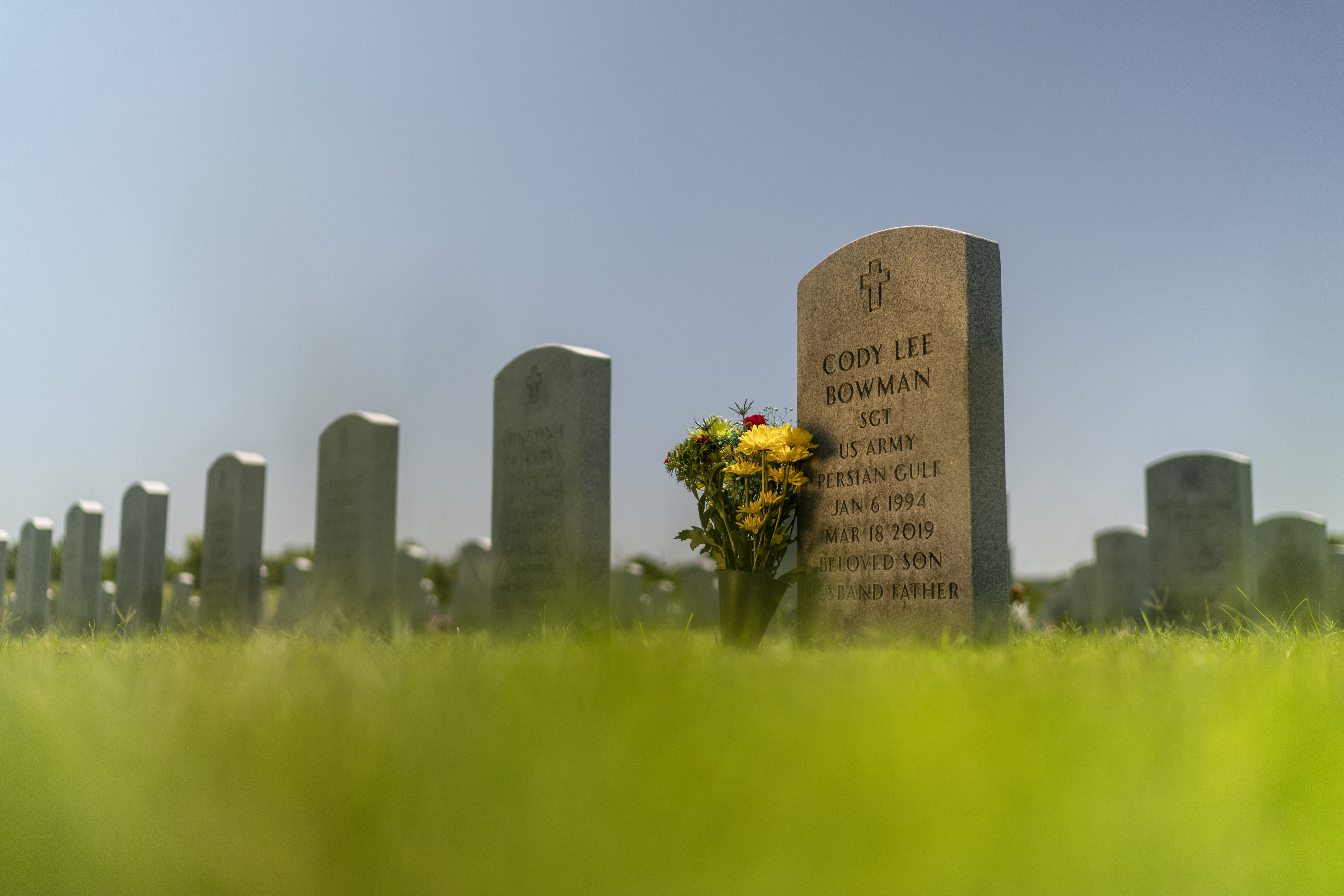 The tombstone of Army Sgt. Cody Bowman stands at the Dallas-Fort Worth National Cemetery, Sunday, June 11, 2023, in Dallas.